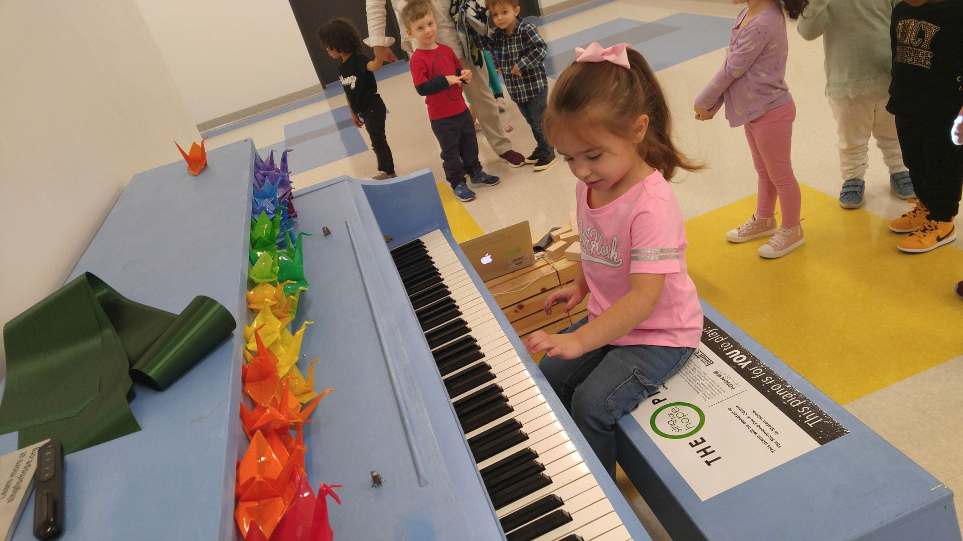 piano at the richmond ave site little girl playing the piano at the richmond prek center