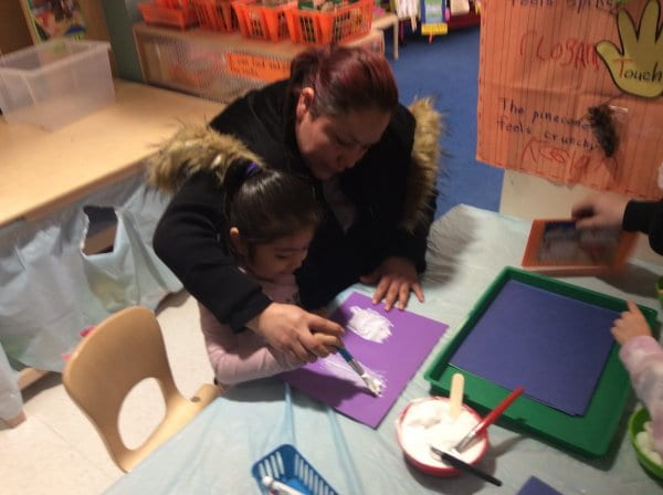 student and mom painting a winter scene.