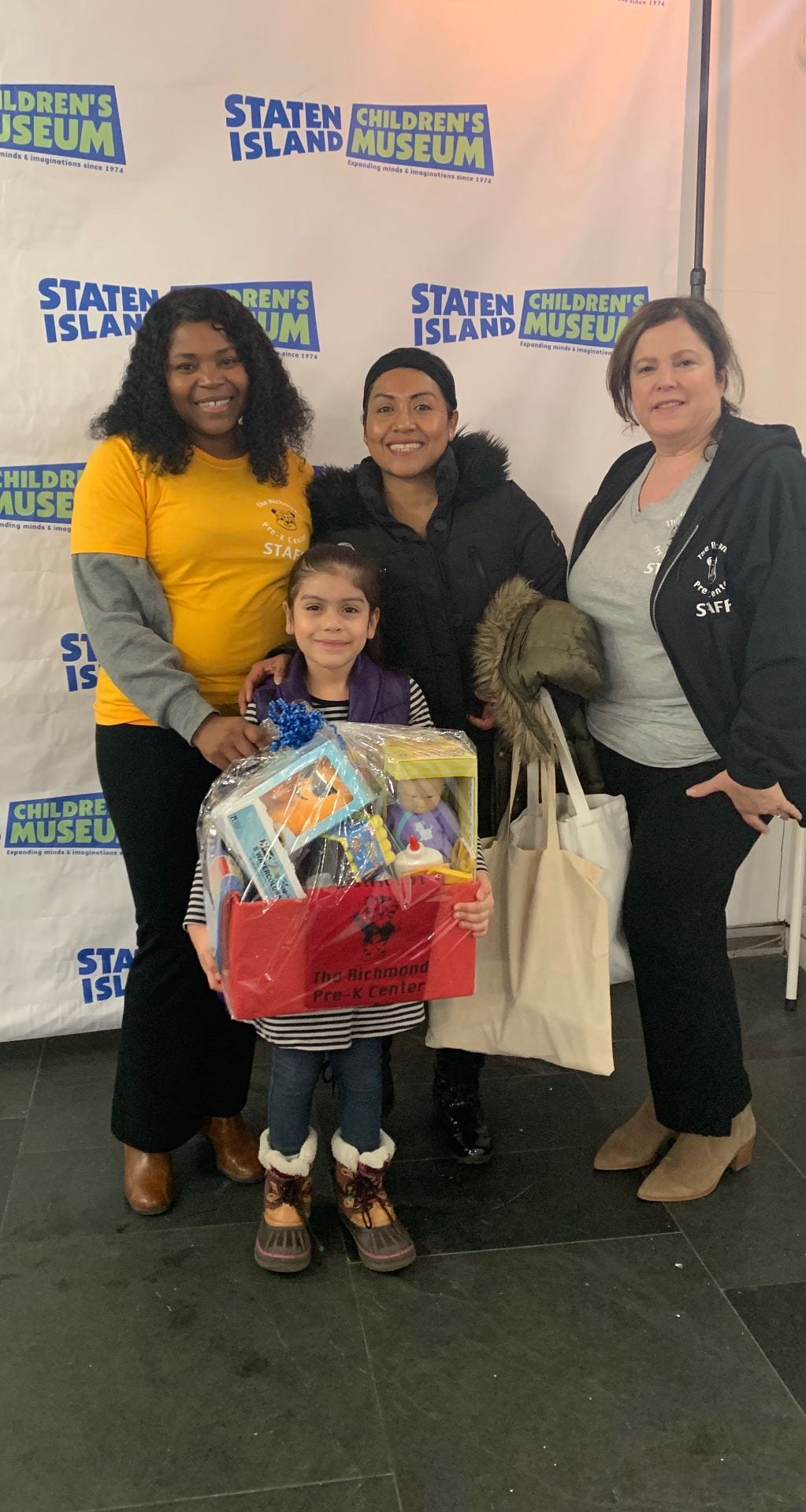 edele williams presenting a gift basket at the 3k/4k 4th annual early learn event