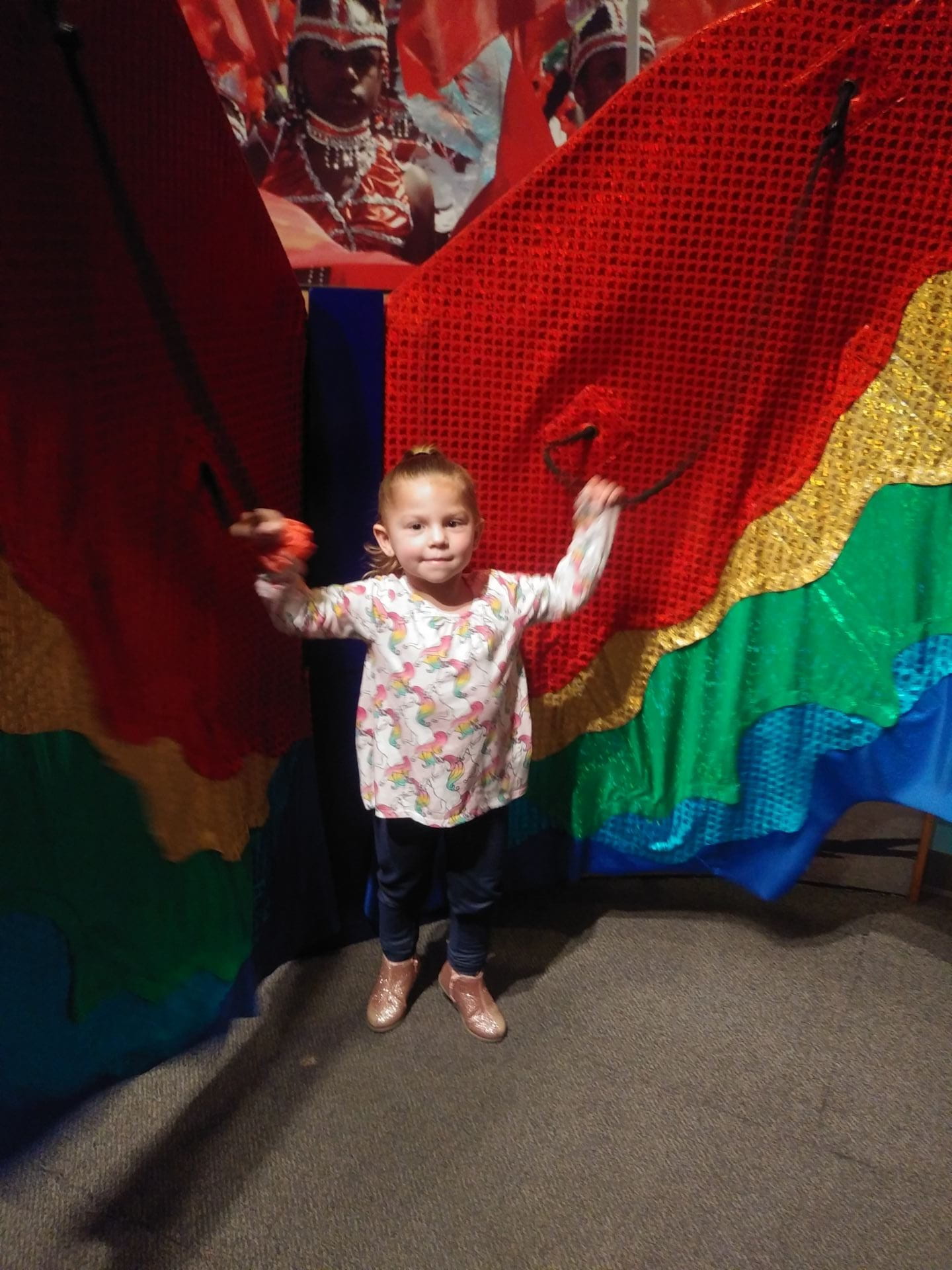 a child standing in front of cultural butterfly wings a child standing in front of cultural butterfly wings