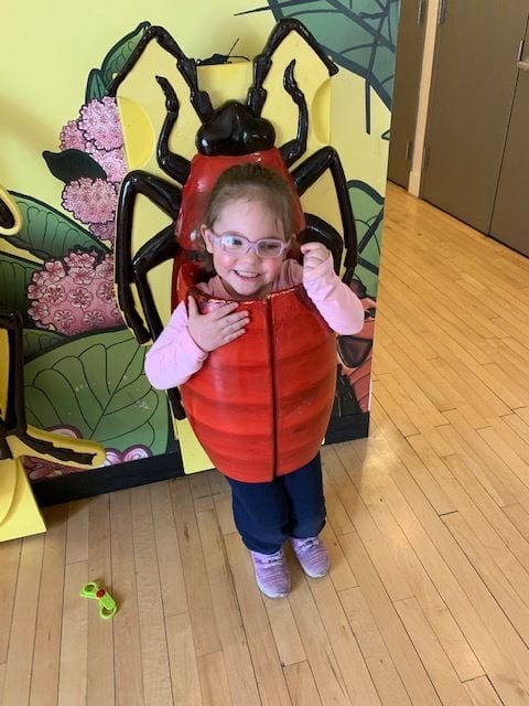 child wearing bug costume at children's museum child wearing bug costume at children's museum