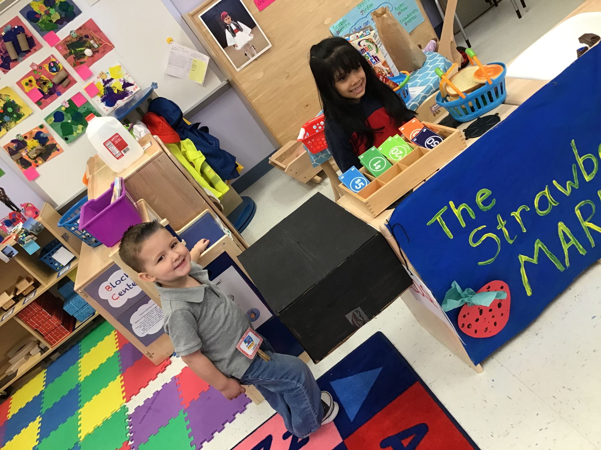 children playing in the dramatic play center transformed into a strawberry market