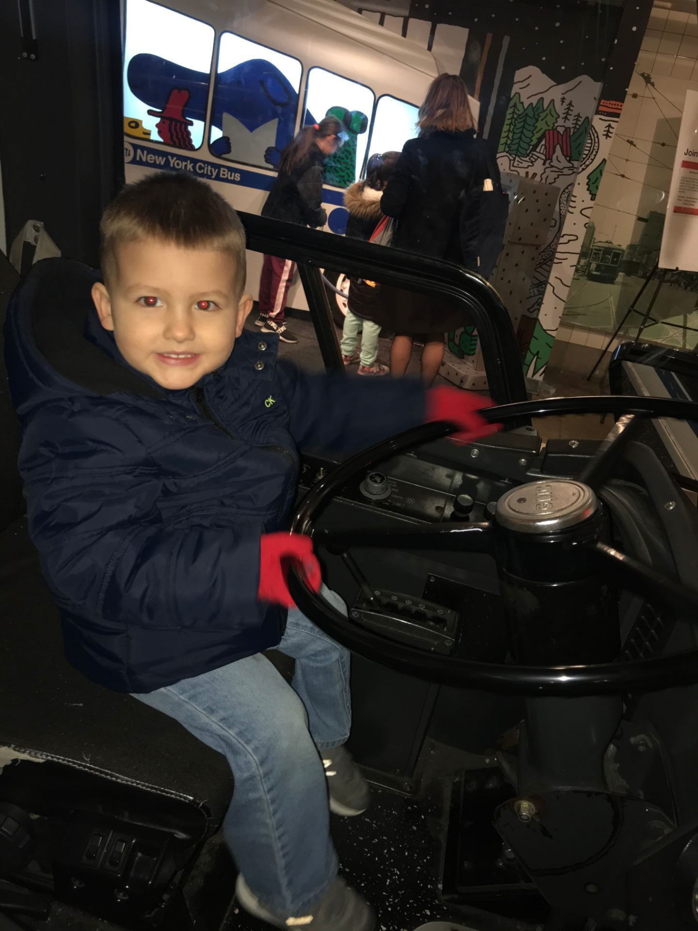child pretending to drive a bus at the NYC transit museum child pretending to drive a bus at the NYC transit museum