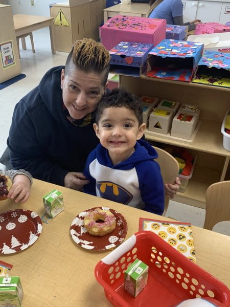 child sharing a donut at parent engagement with their family member 