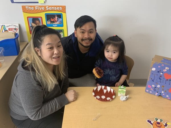 child sharing a snack with her family during parent engagement child sharing a snack with her family during parent engagement