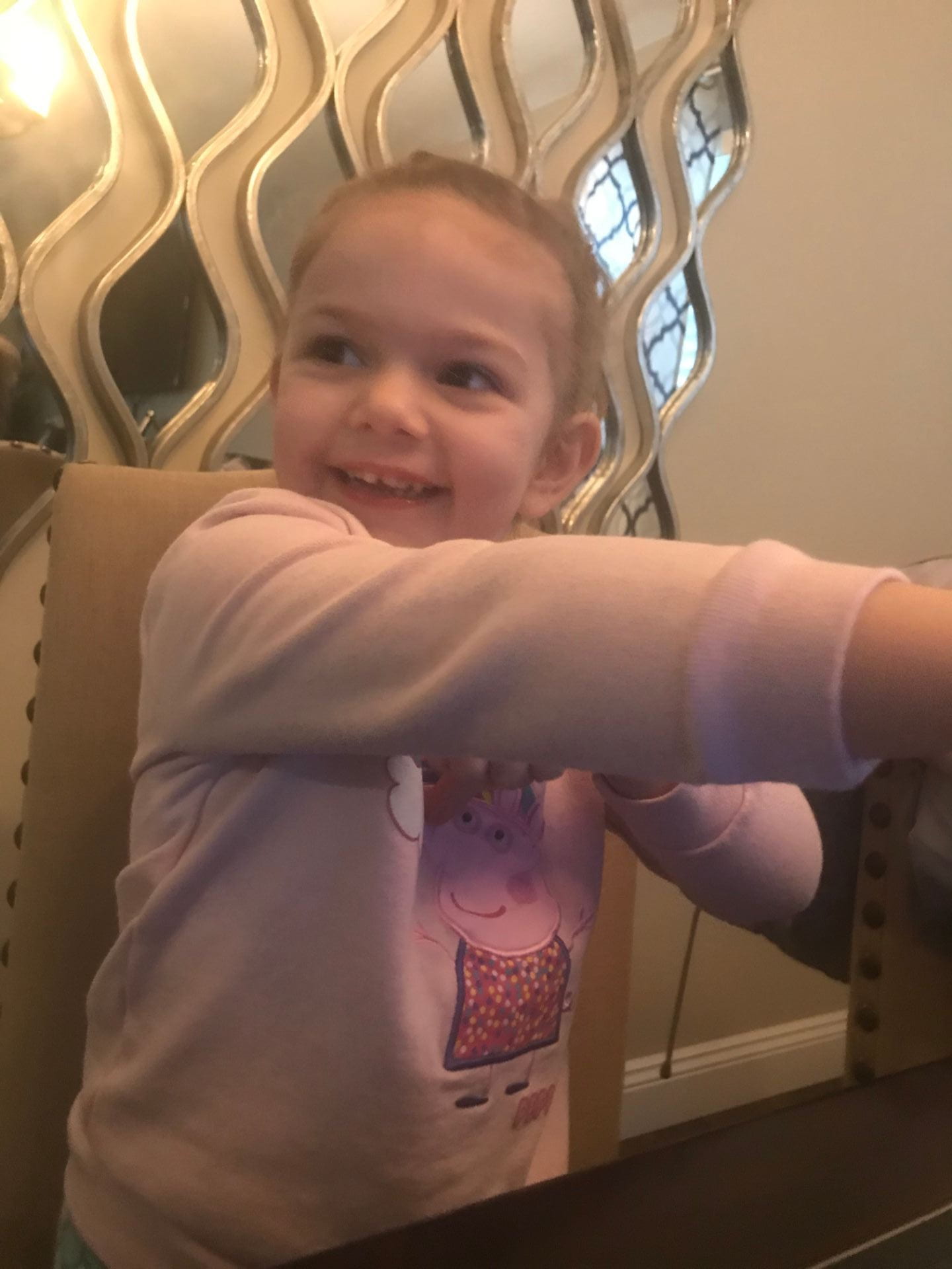 little girl wearing peppa pig shirt