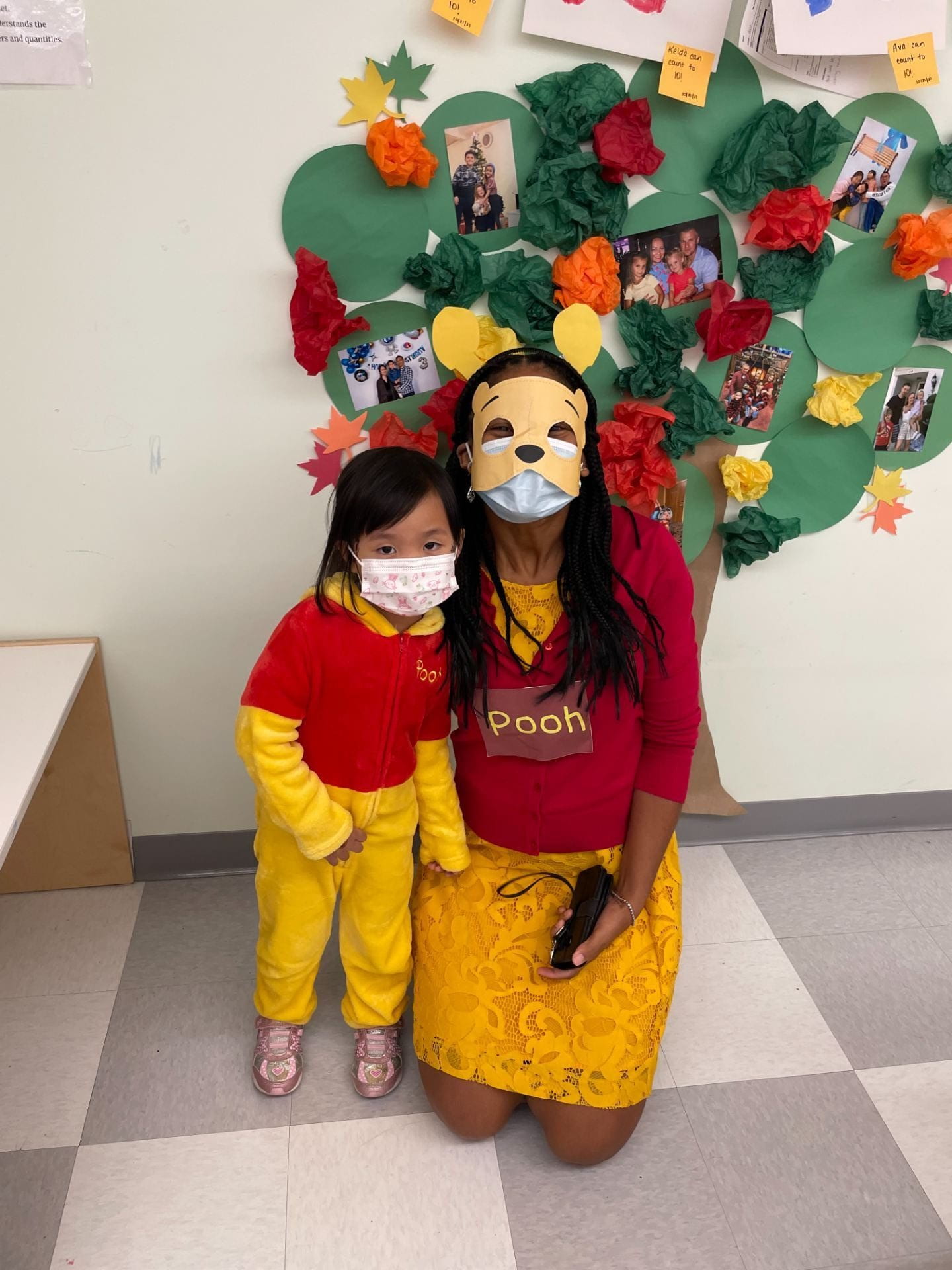 Ms. Dure dressed as Pooh taking a photo with mini ooh