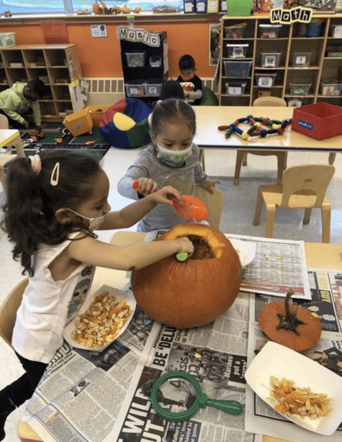 Students exploring the inside of a pumpkin